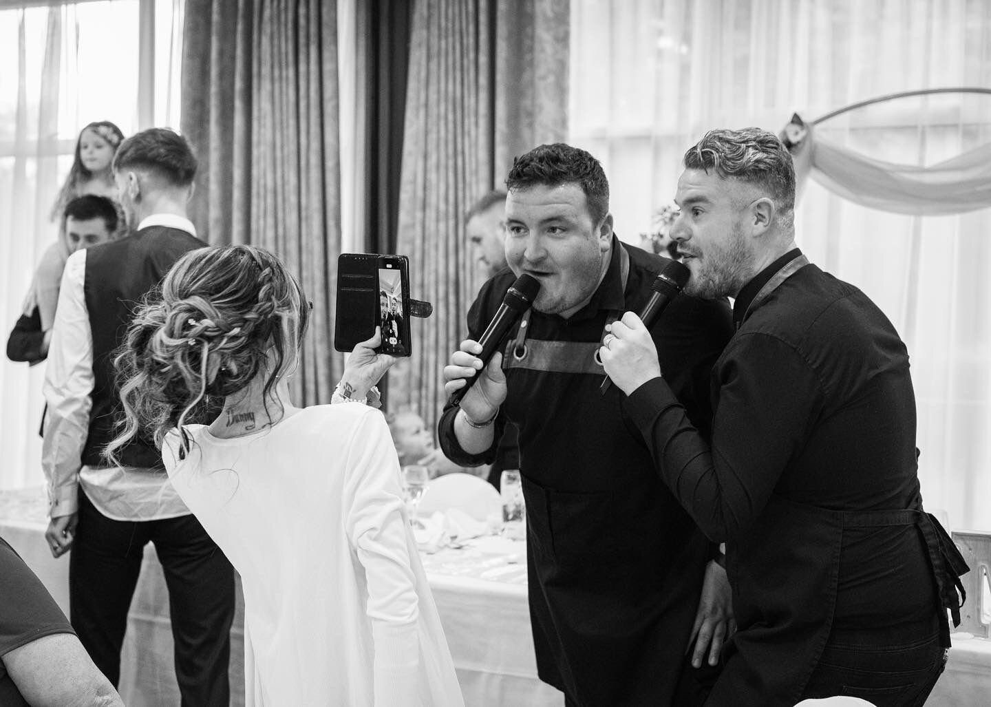 Singing waiters performing to a bride at her wedding reception