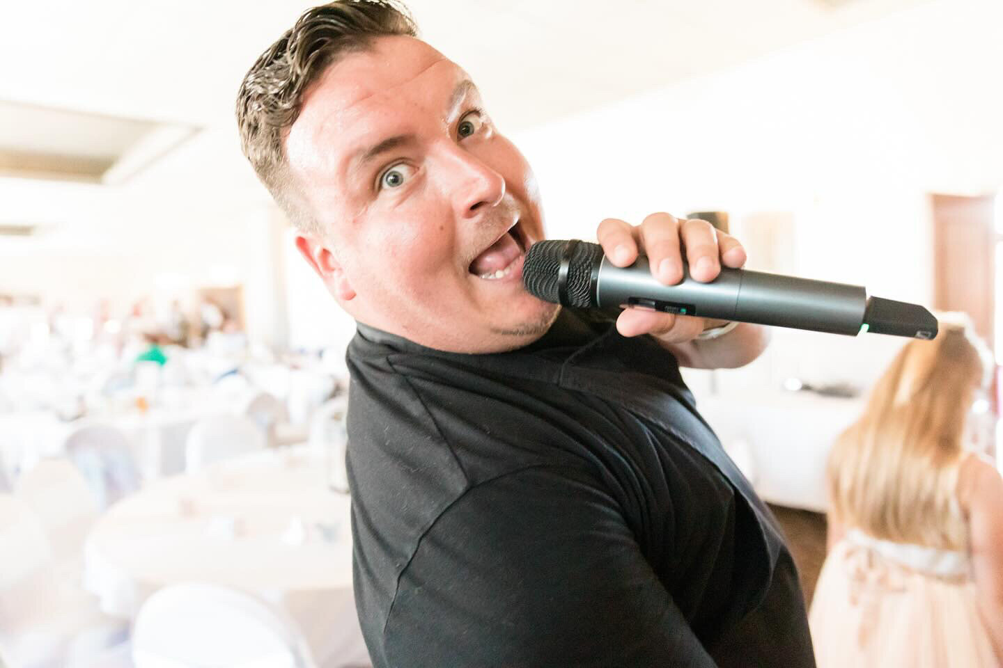 Singing waiter performing with a microphone at a wedding