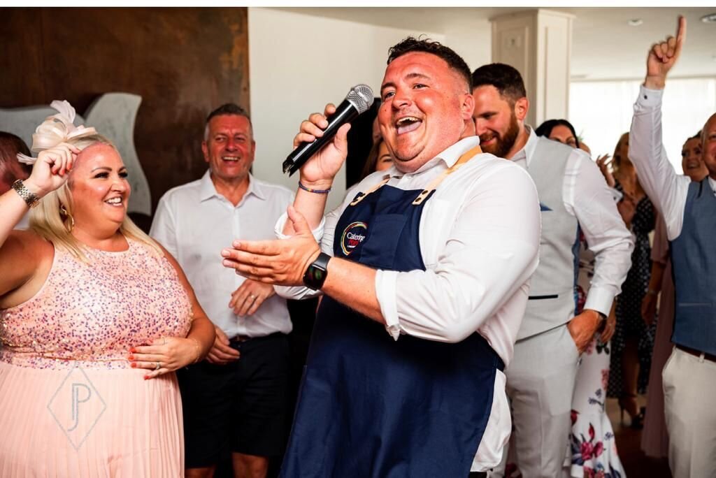 Singing waiter performing with a guest at a party
