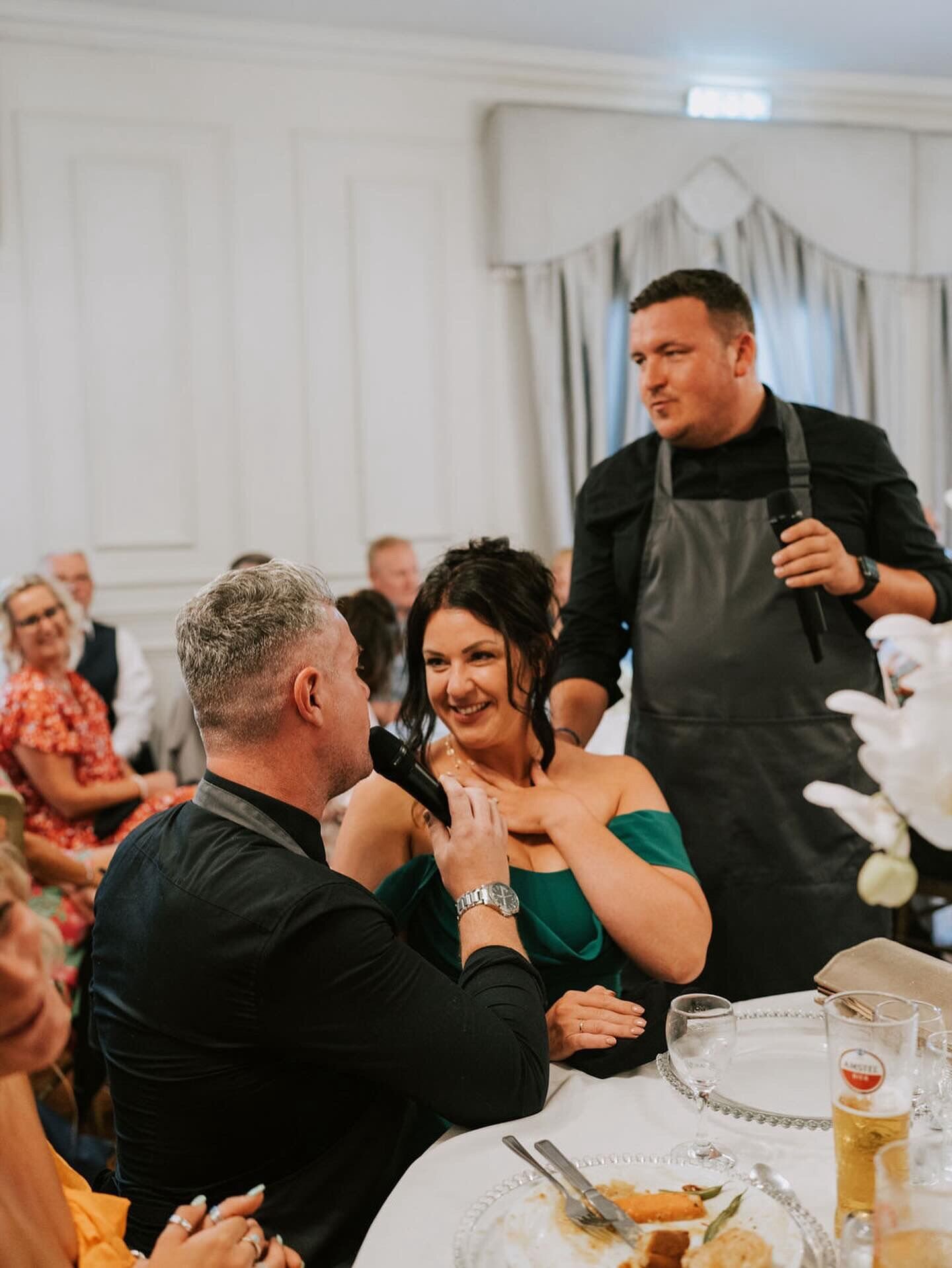 Singing waiters surprising wedding guests at their table