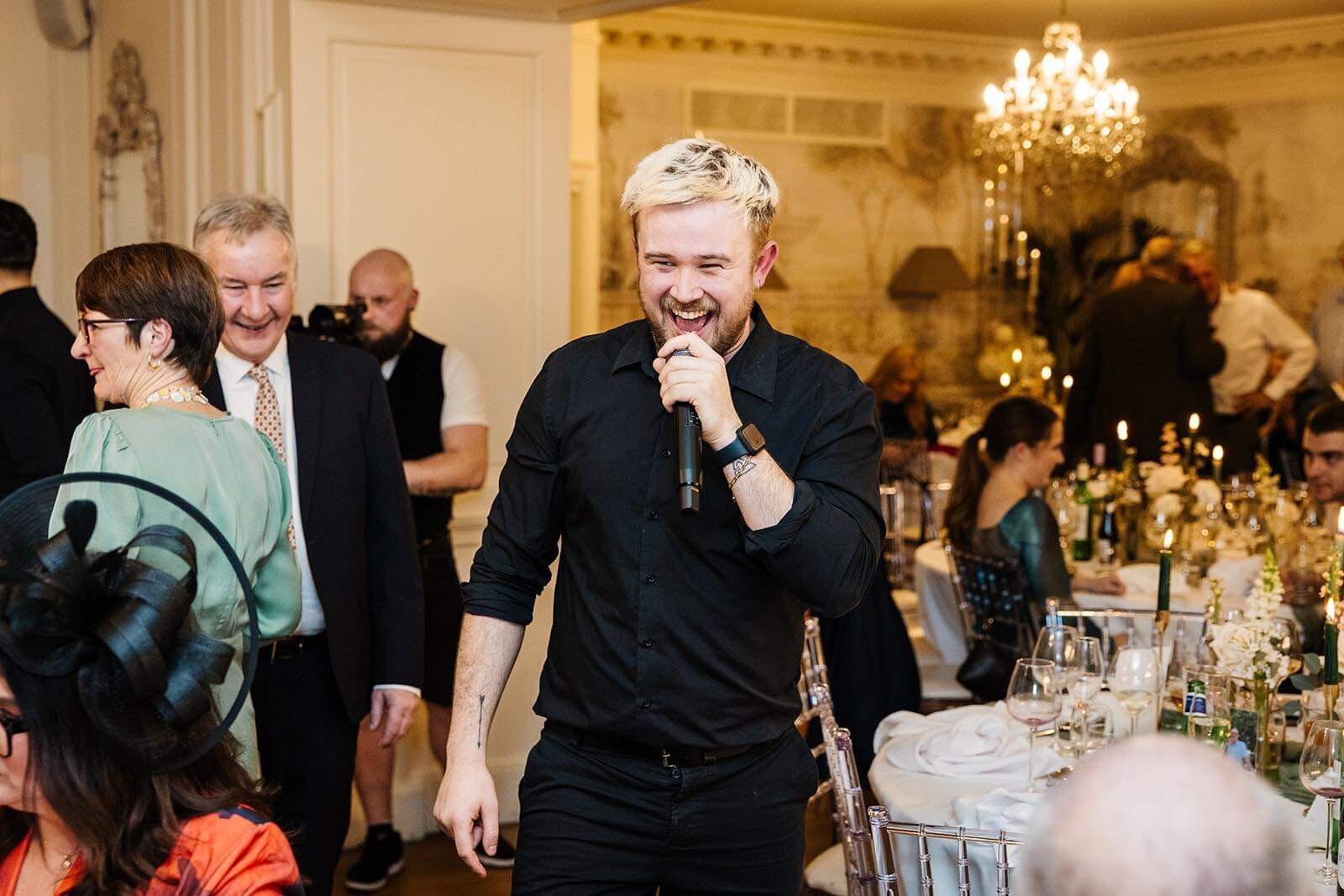 Singing waiter walking through wedding guests mid-song