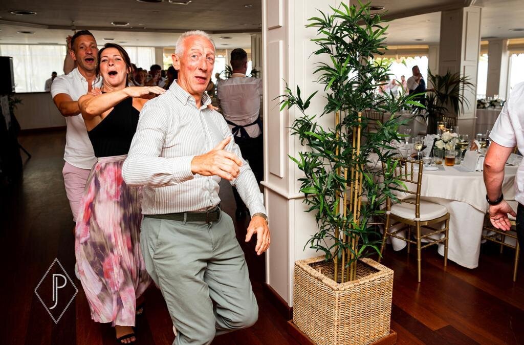Guests dancing with a singing waiter at a party