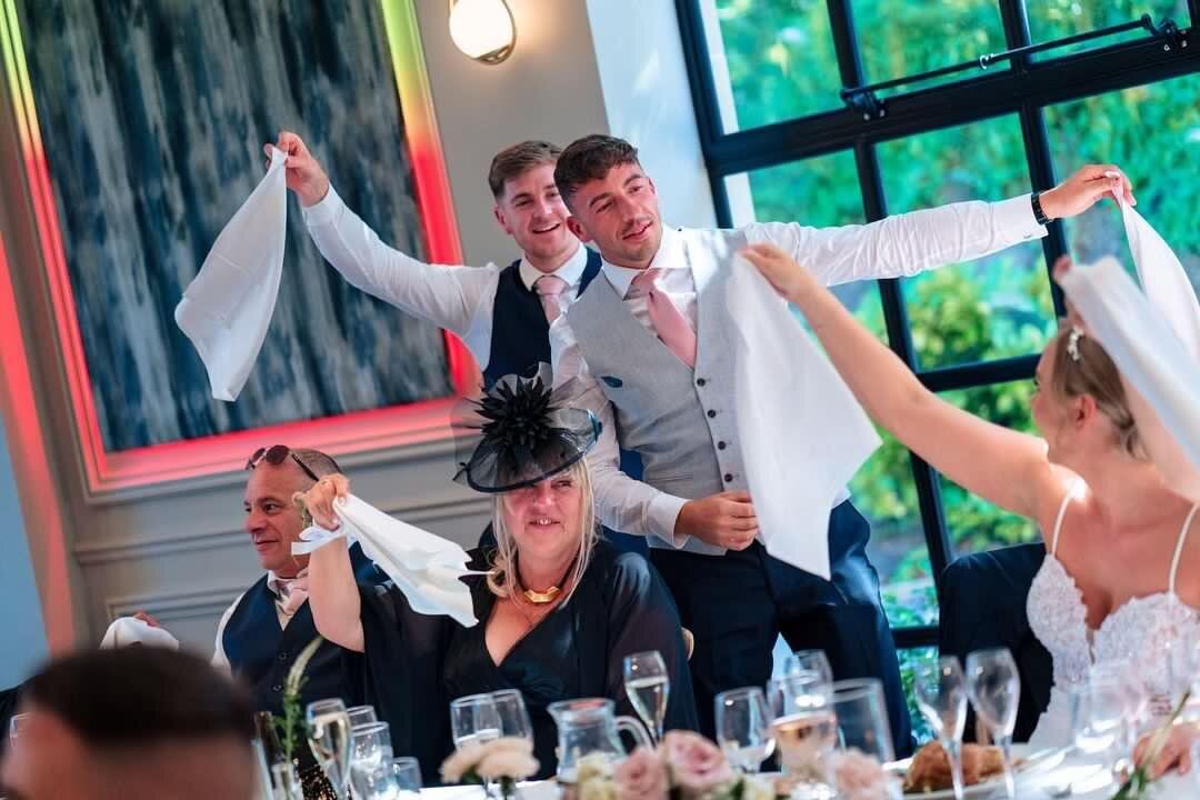 Guests waving napkins as singing waiters perform