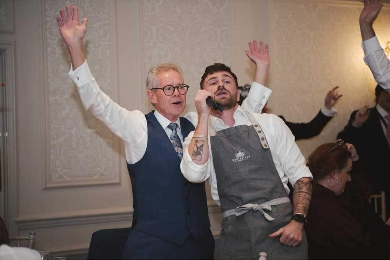 Singing waiter and a guest dancing at a wedding