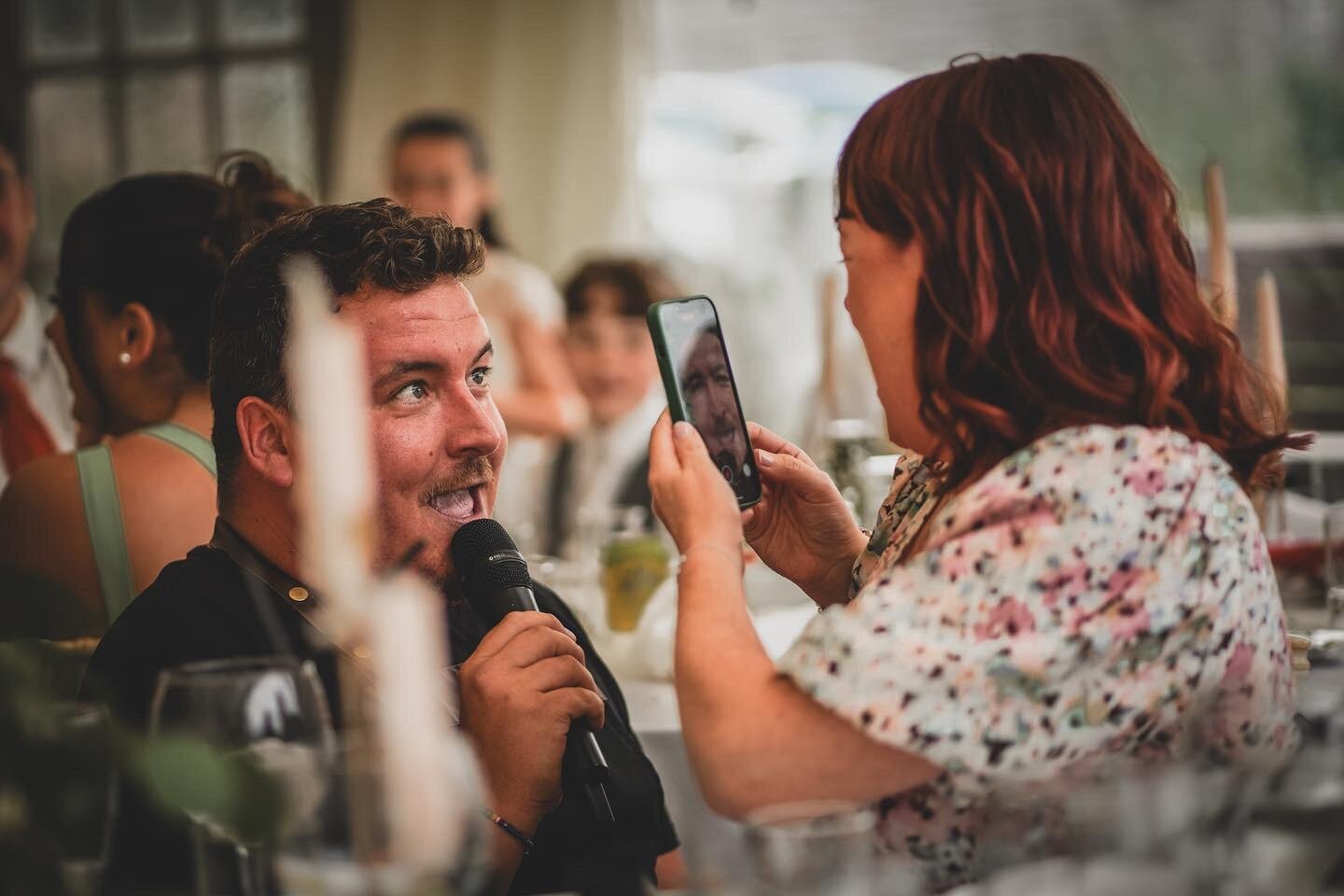 Guest filming a singing waiter on her phone