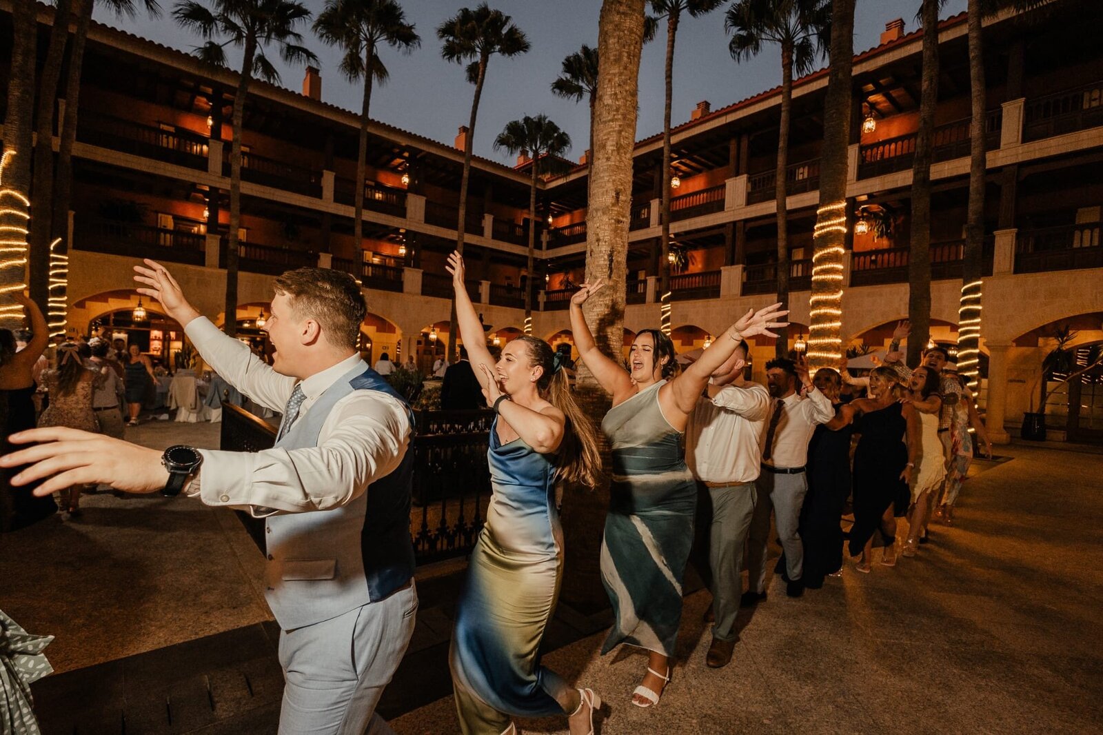 Singing waiters performing at an evening destination wedding reception abroad