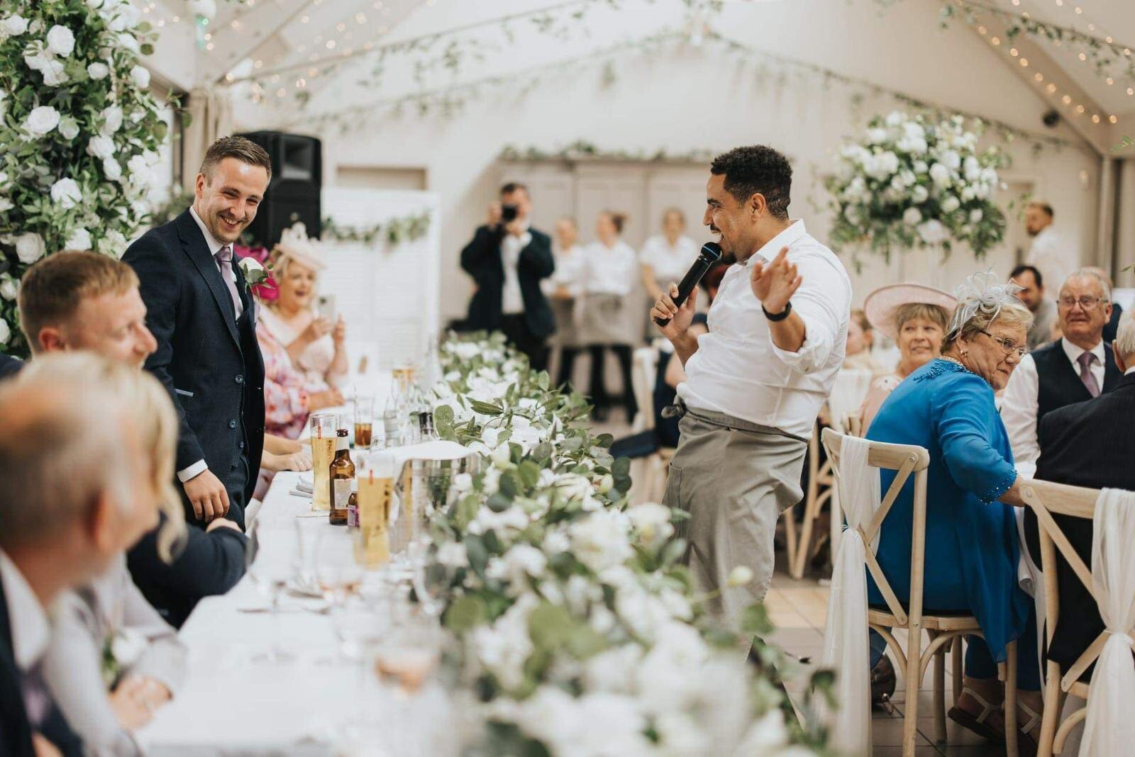 Singing waiters performing along a long wedding table
