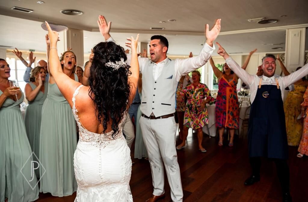 Bride and guests dancing with the singing waiters