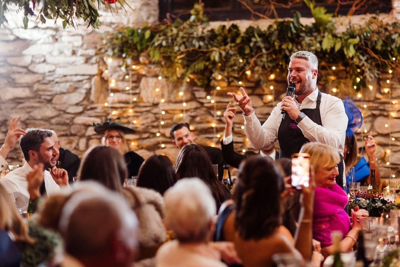 Singing waiter performing in a rustic stone wedding venue
