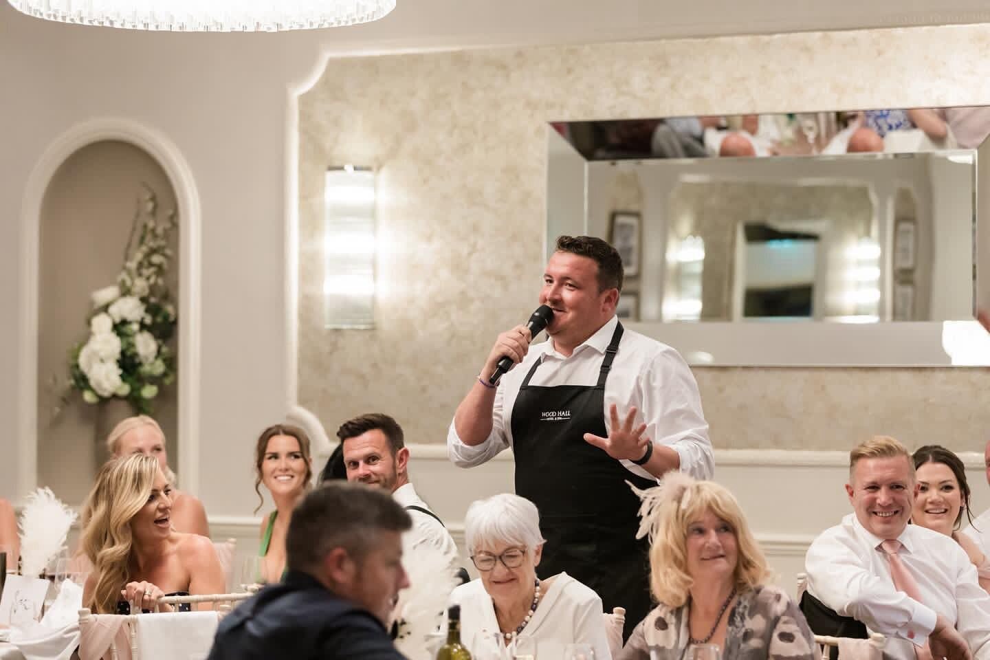 Singing waiters performing to seated wedding guests