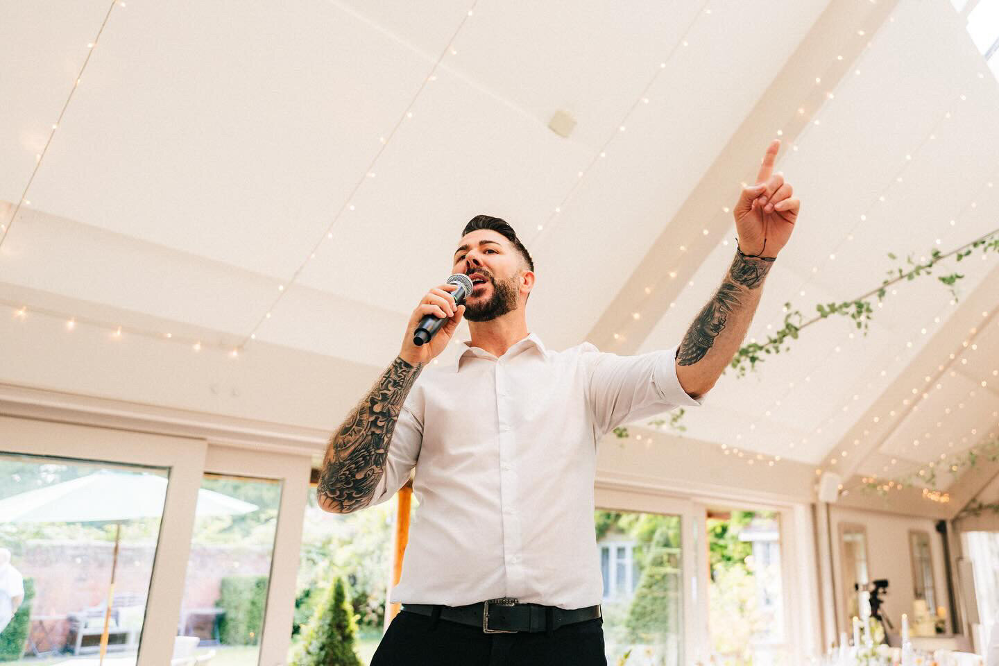 Singing waiter performing in a bright wedding venue
