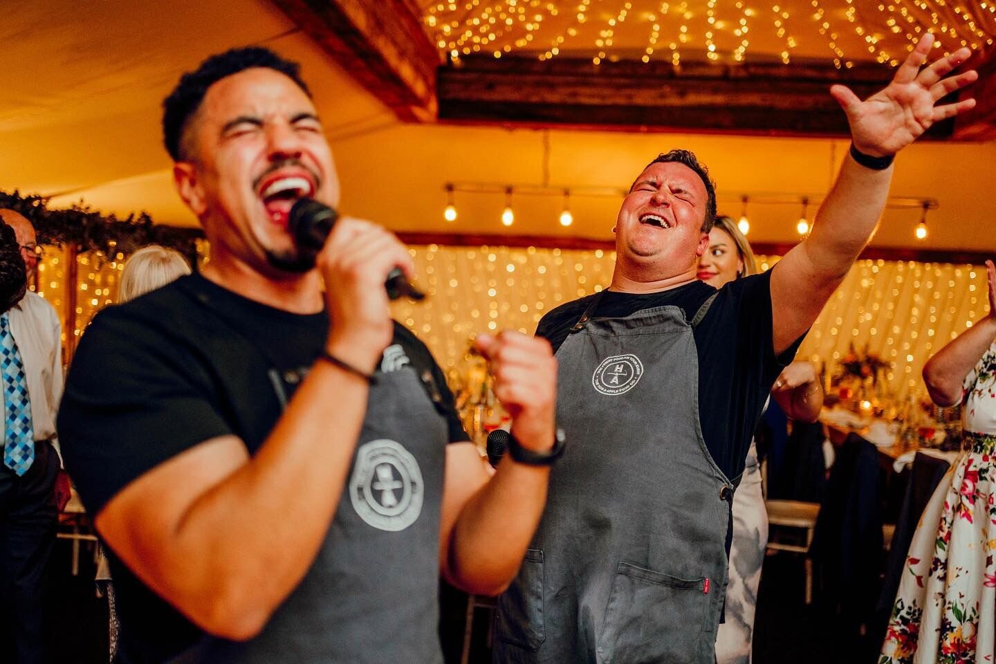 Singing waiters belting out a song at a lively party