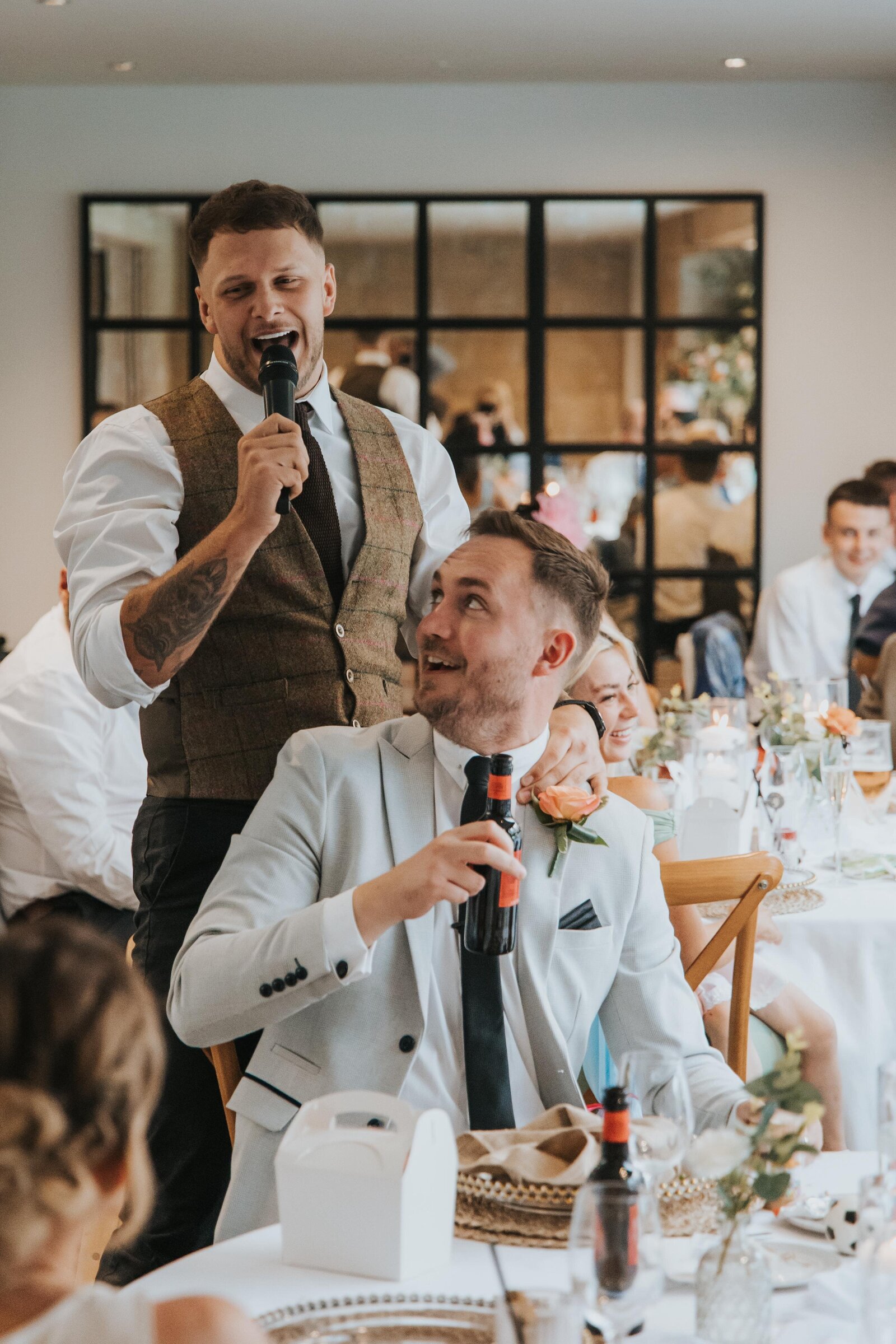 Singing waiters performing to guests at a table at a wedding