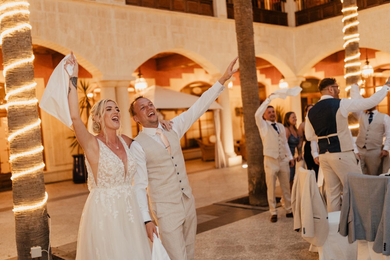 Bride and groom dancing as singing waiters perform at a wedding abroad