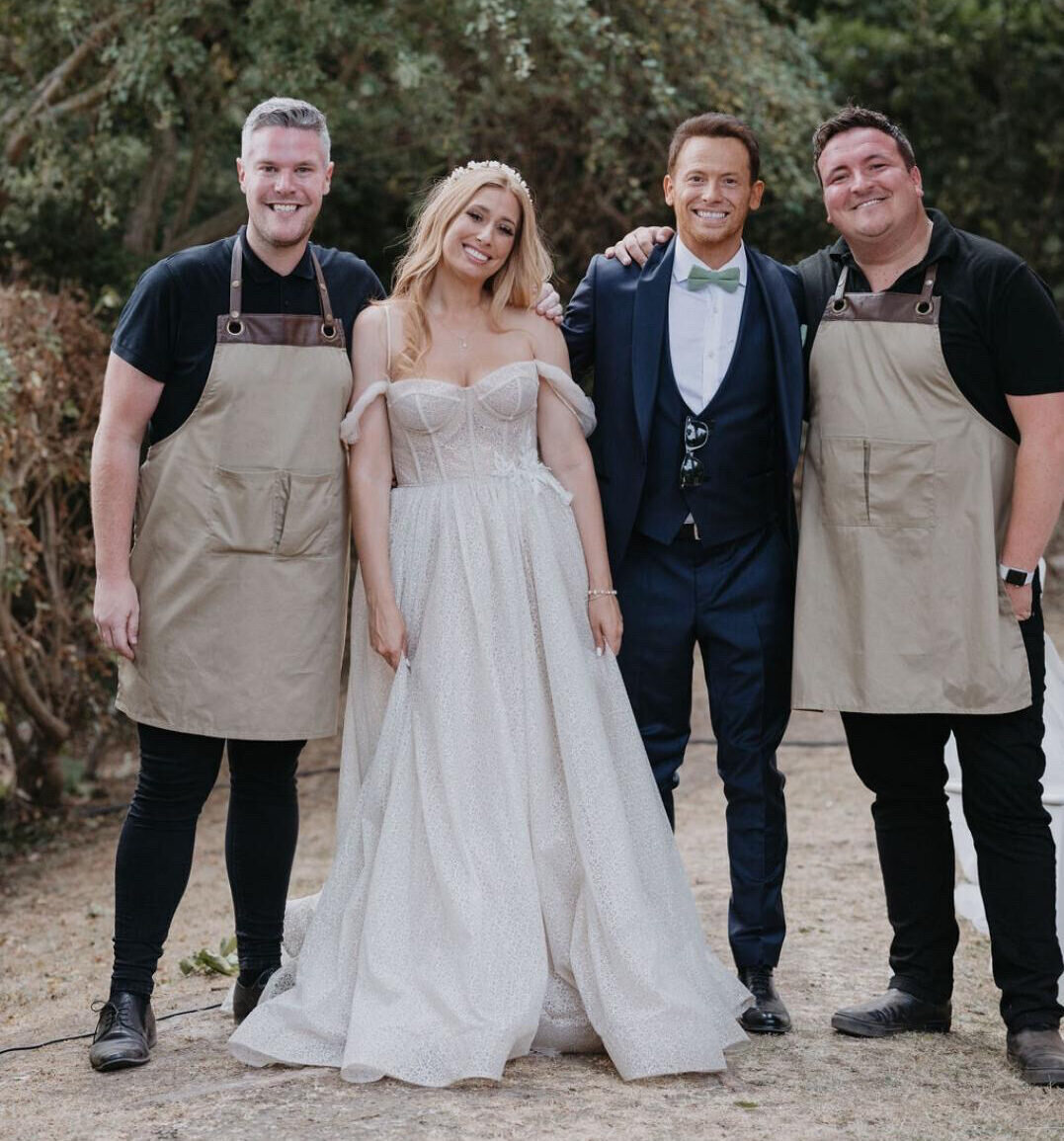 The Undercover Waiters singing waiters with a bride and groom on their wedding day