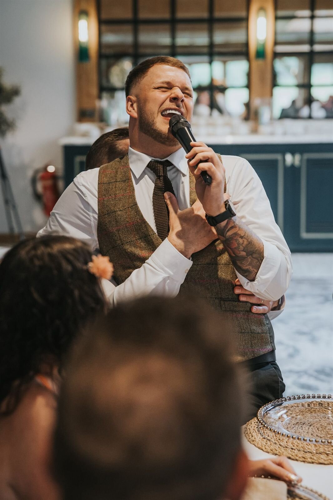 Singing waiter performing to wedding guests