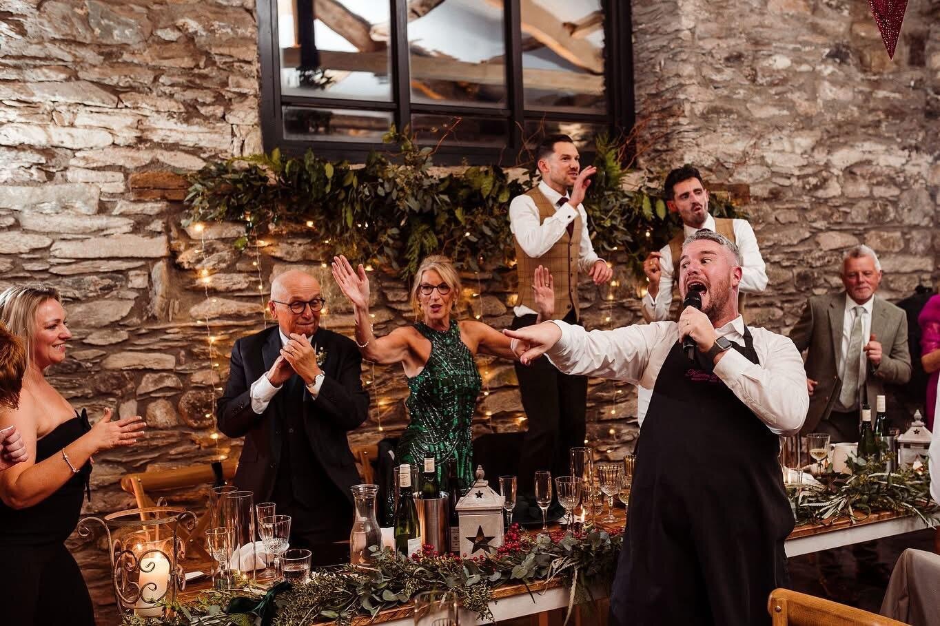 Singing waiters performing in a stone-walled wedding venue