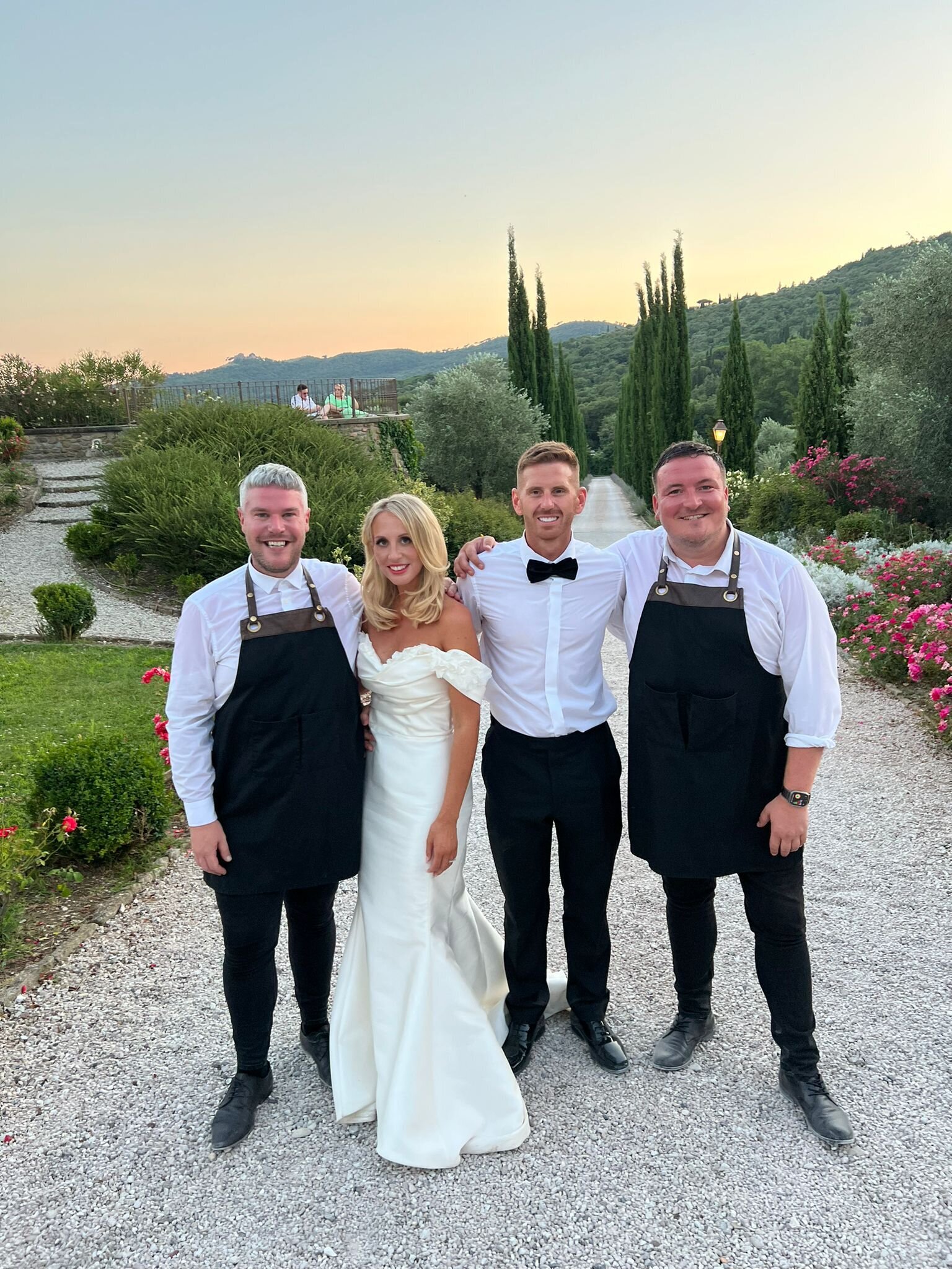 Singing waiters with the bride and groom at a destination wedding abroad