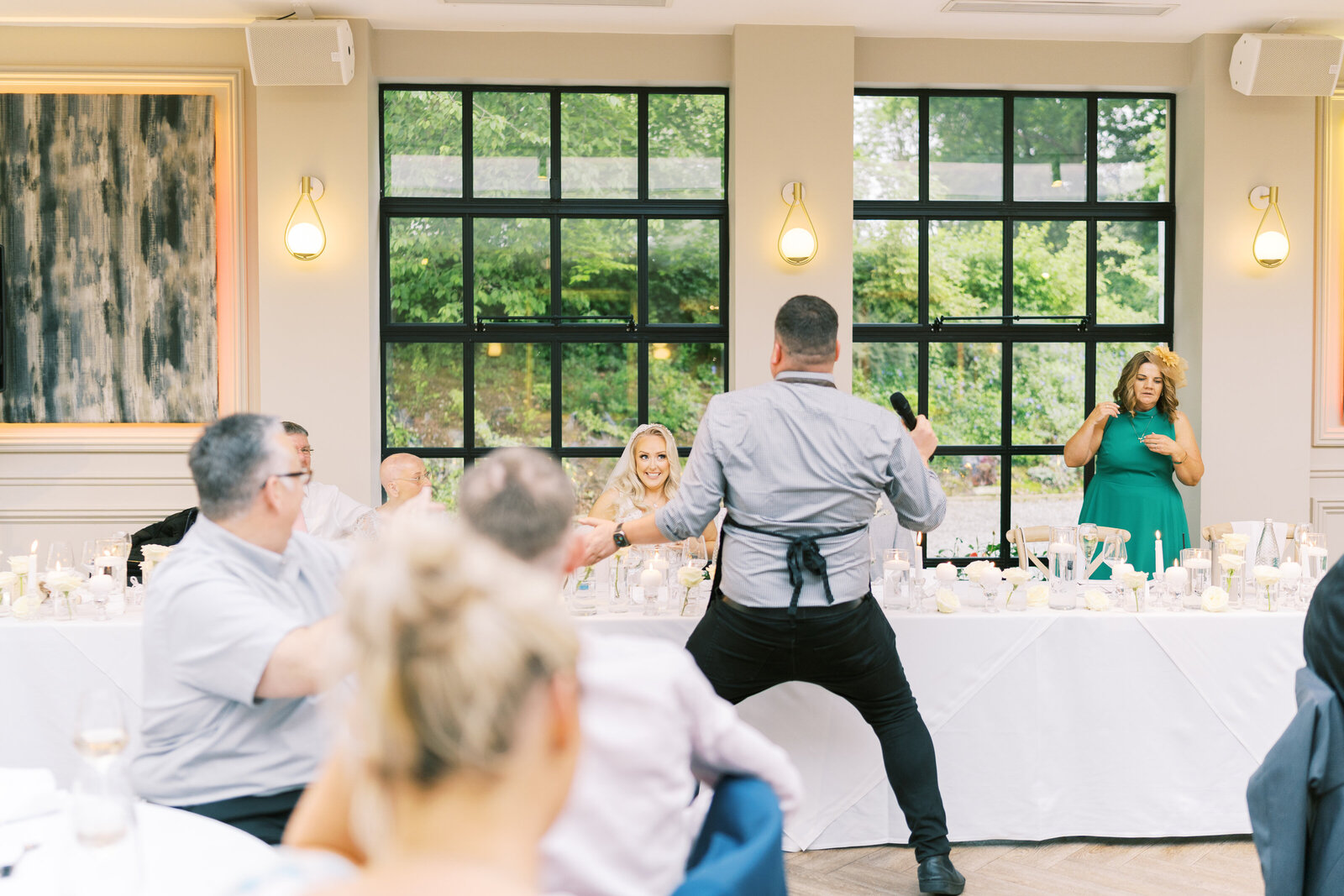 Singing waiter dancing between tables at a wedding