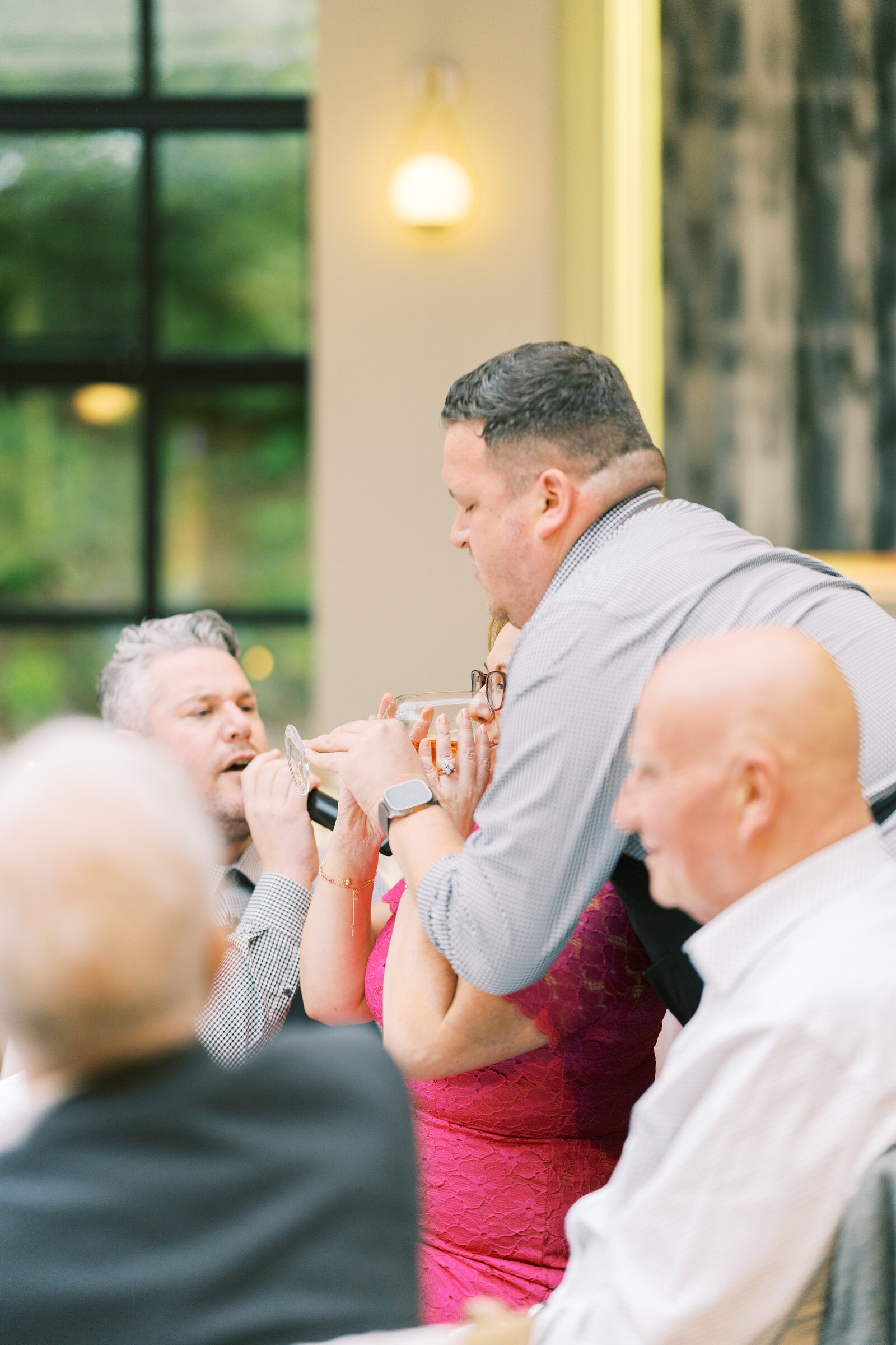 Singing waiter serenading a guest at a wedding