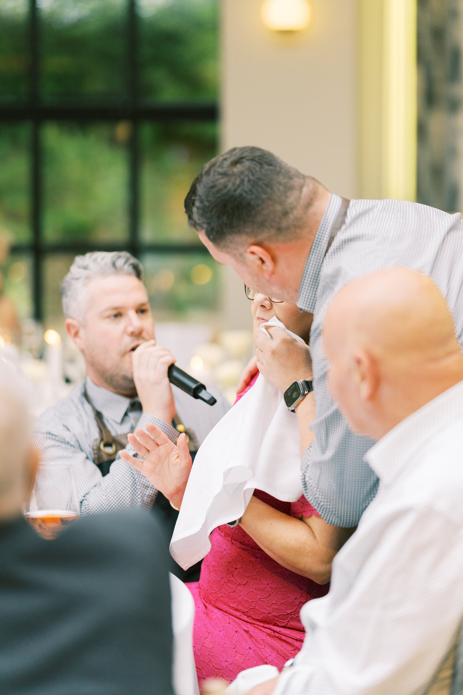 Singing waiter serenading a guest at her table