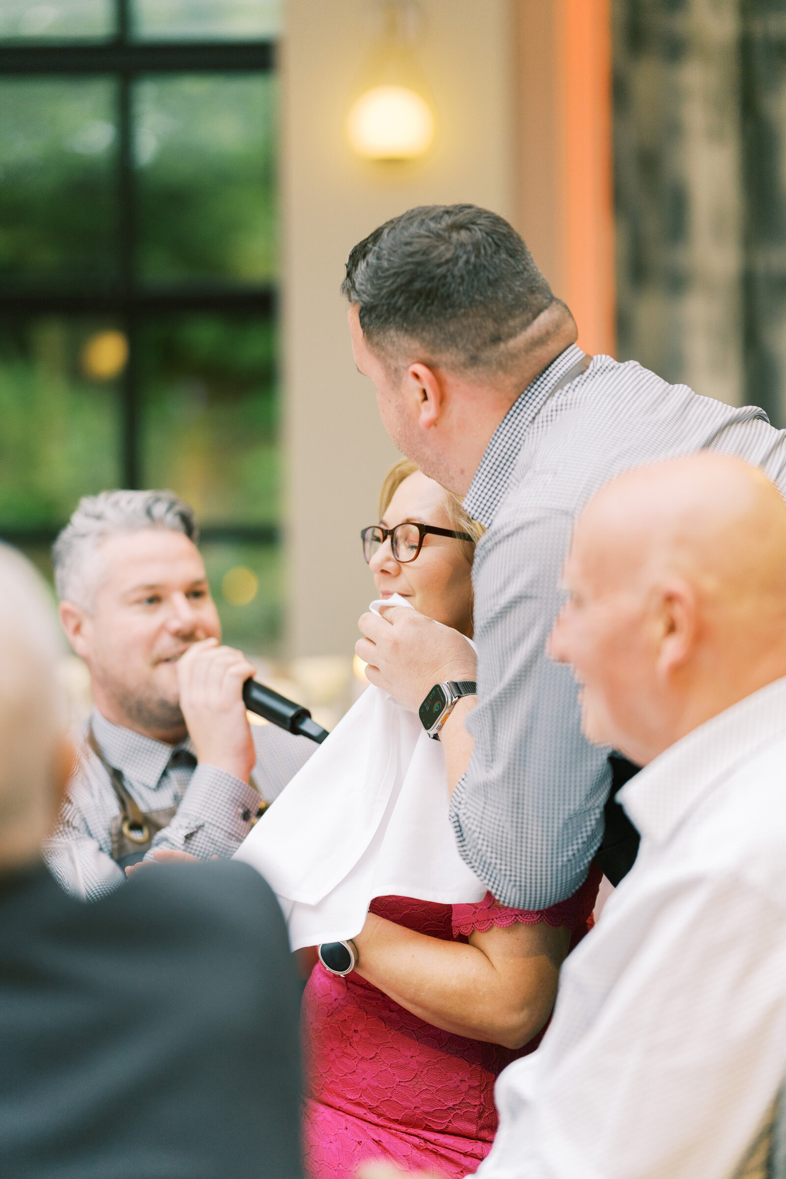 Singing waiter serenading a guest at her table