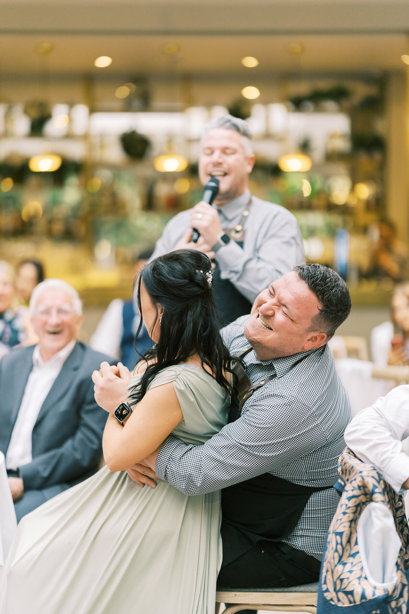 Singing waiter serenading a bride as guests laugh