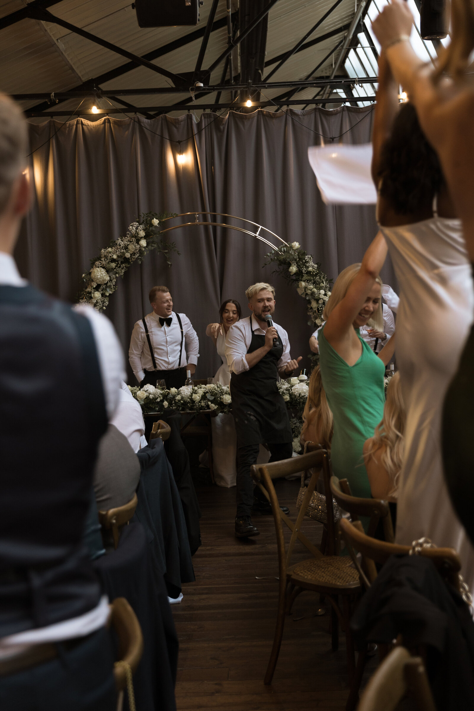 Guest dancing during a singing waiters performance at a wedding