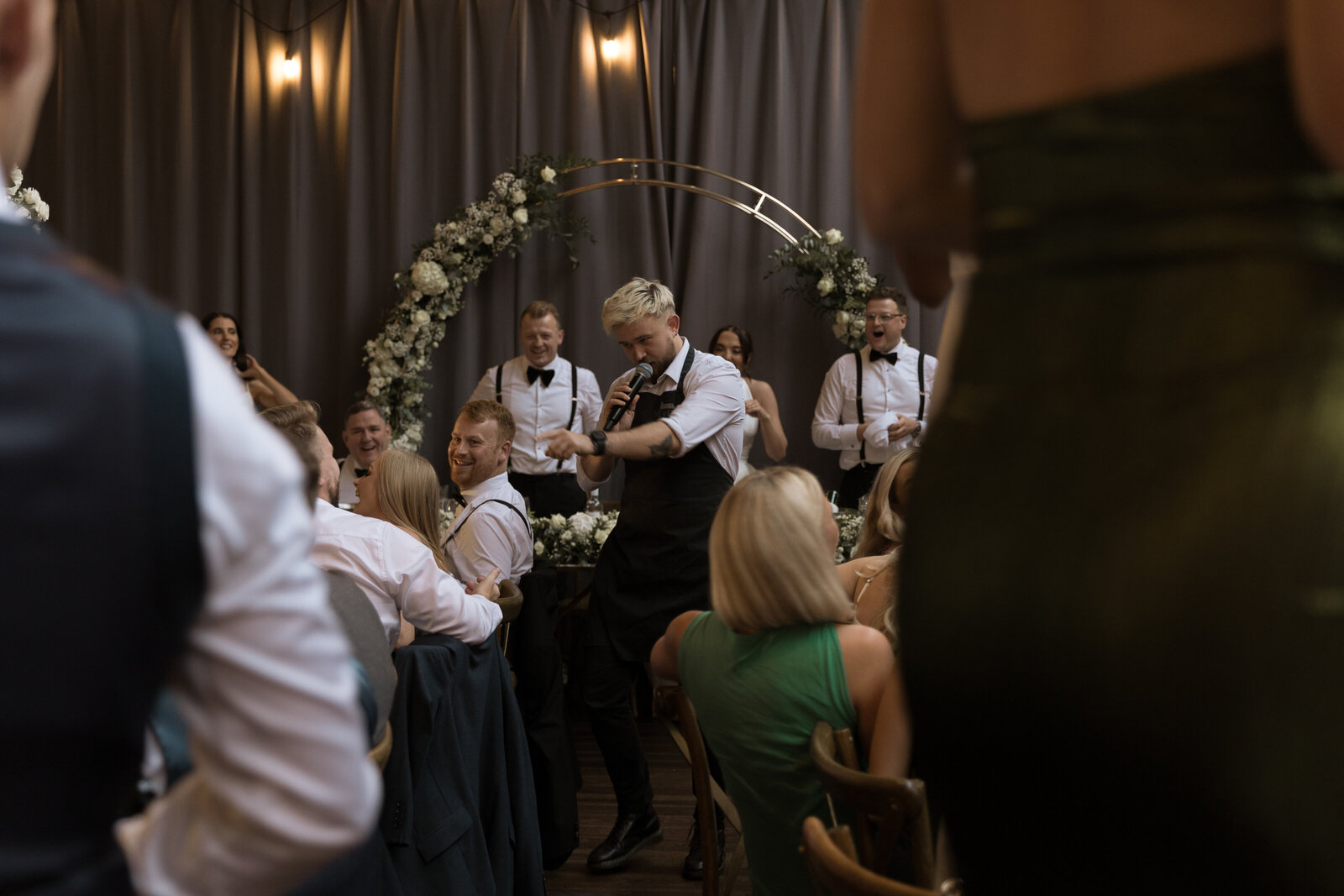 Guests watching the singing waiters perform at an evening reception