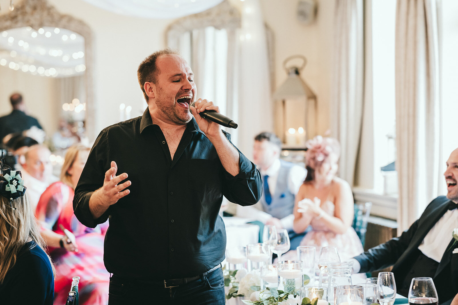 Singing waiter performing to wedding guests