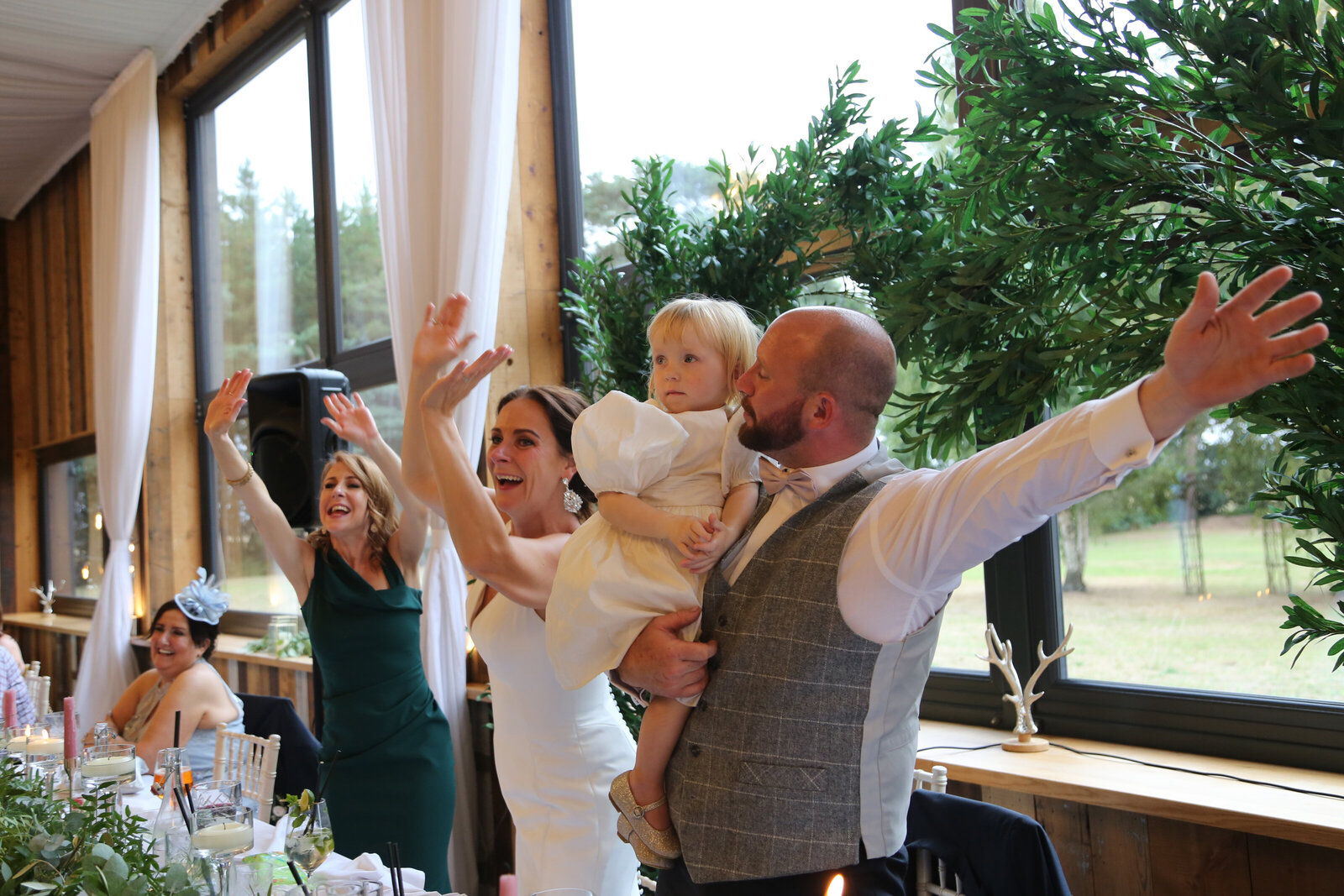 Guests dancing by the windows during a singing waiters performance