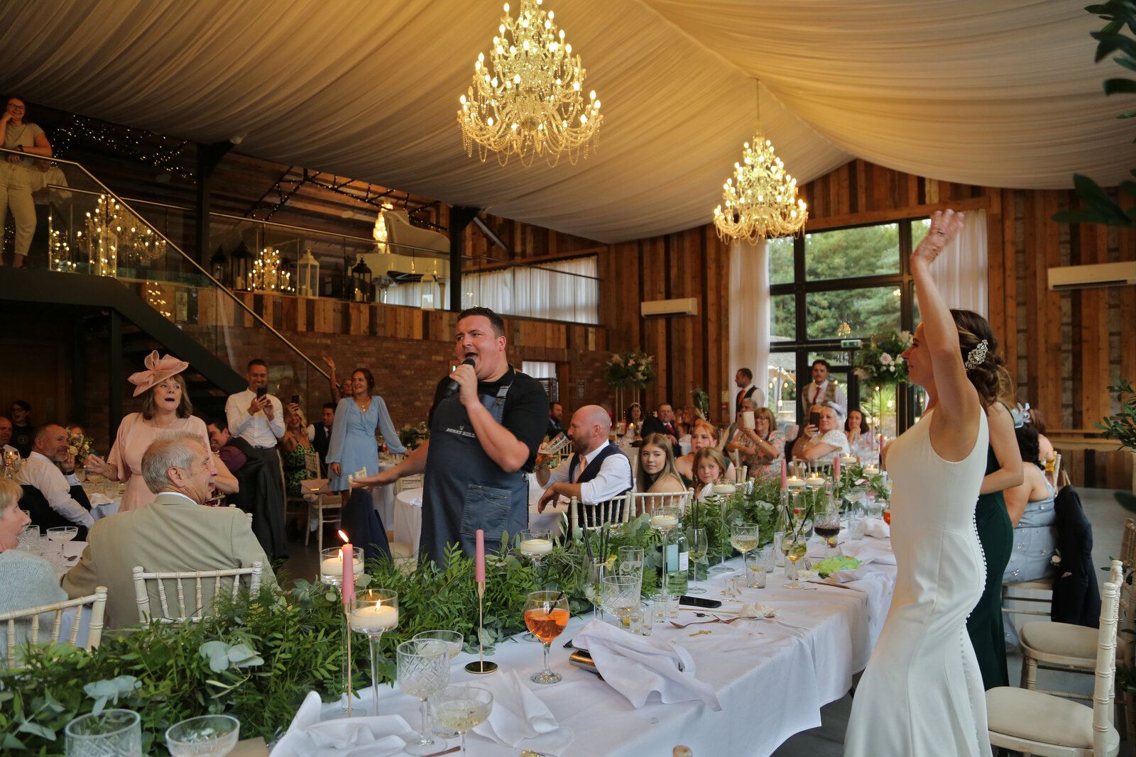 Singing waiters performing along a long wedding table