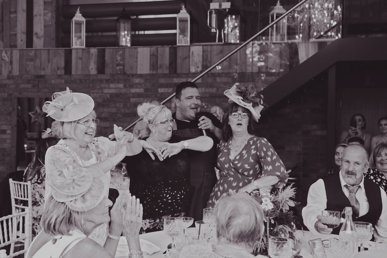 Guests singing along with the singing waiters, black and white