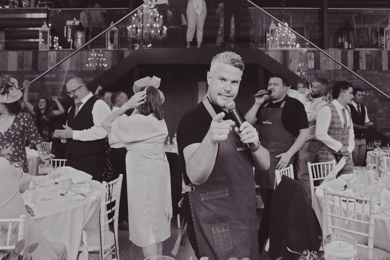 Singing waiters performing to guests, black and white
