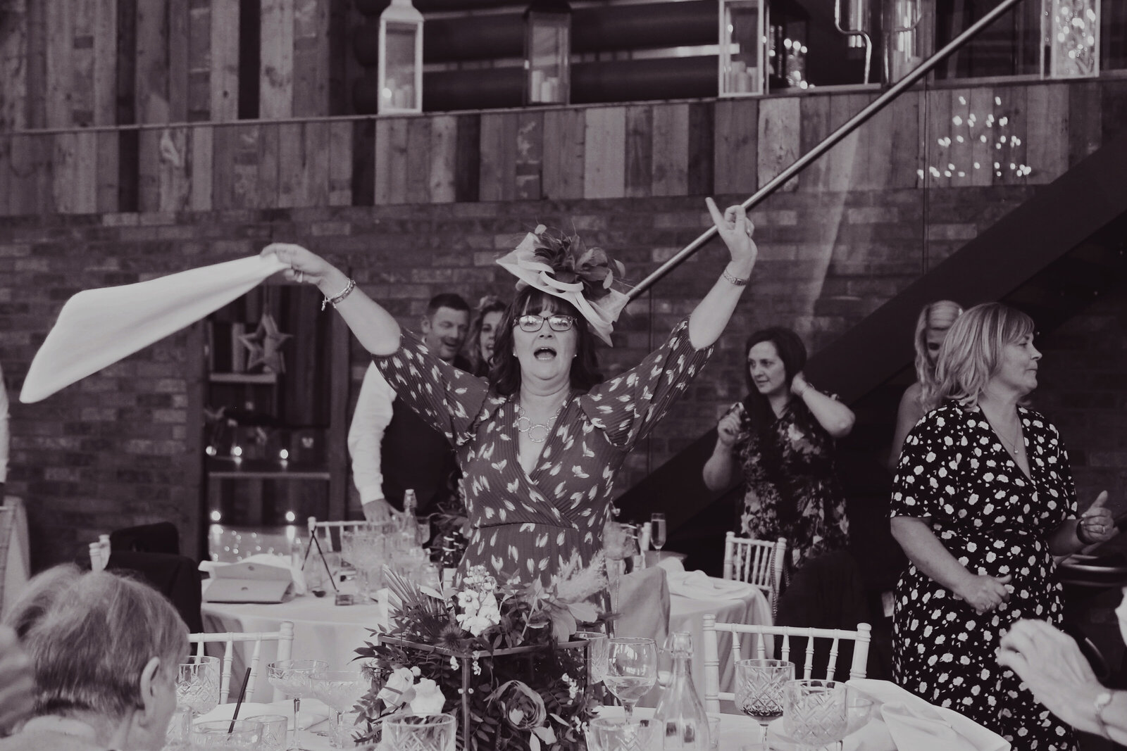 Guest waving a napkin during a singing waiters performance, black and white