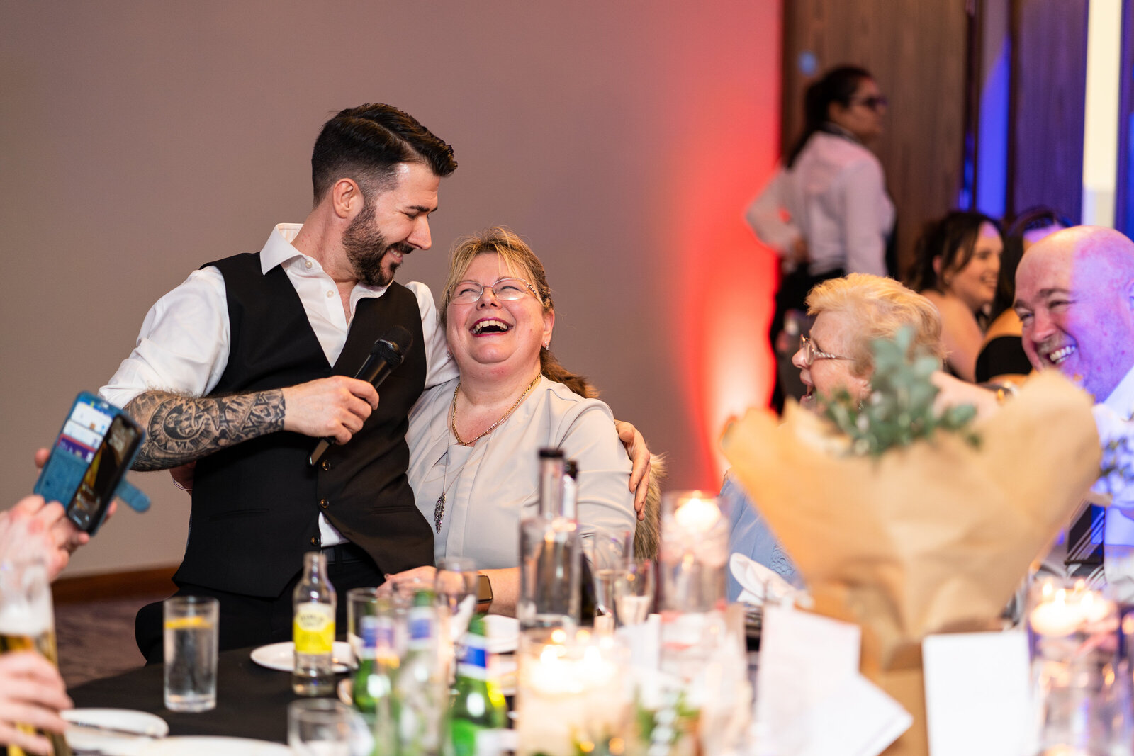 Singing waiter sharing a laugh with a guest at an event