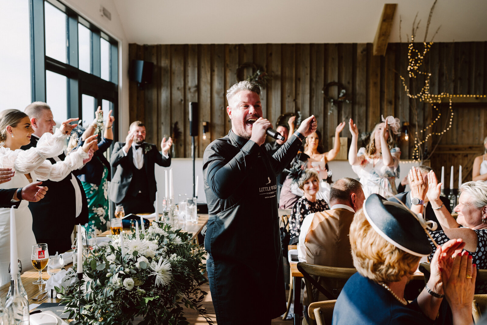 Singing waiter performing to guests at a wedding breakfast