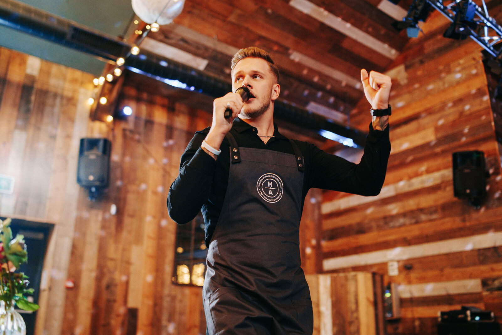 Singing waiter performing in a rustic barn venue