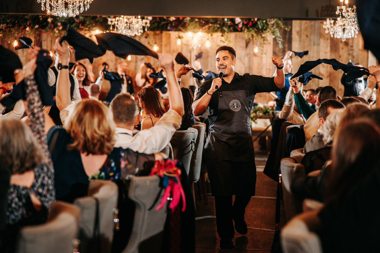 Wedding guests waving napkins at a singing waiters performance