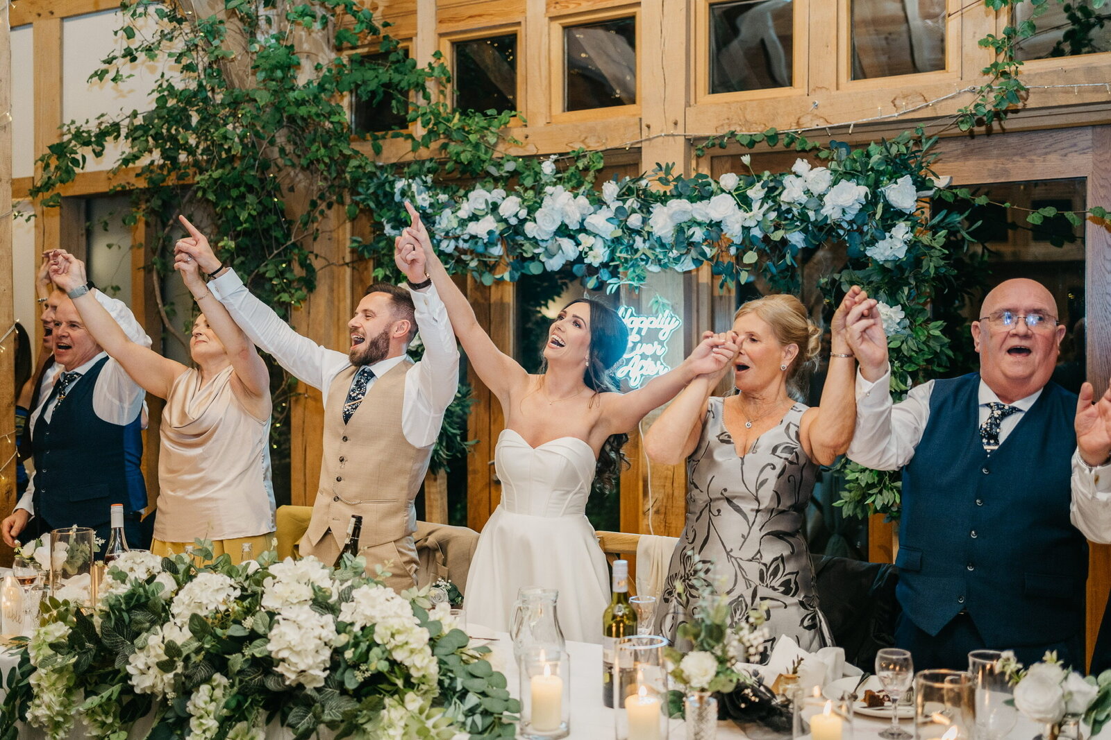 Wedding guests on their feet cheering during a surprise singing waiters performance