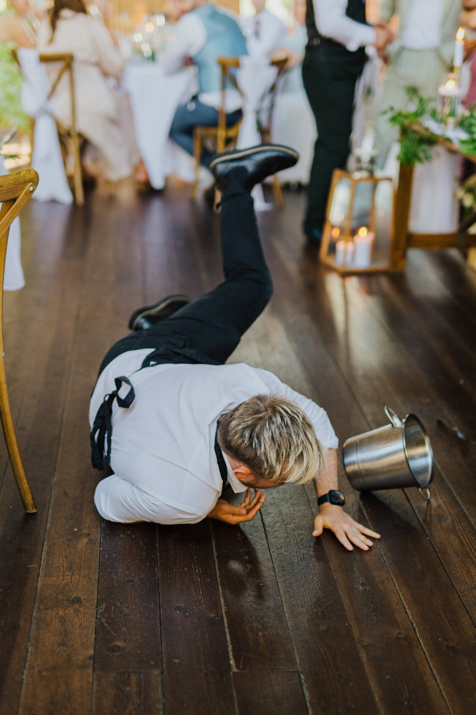 Singing waiter sliding across the dance floor mid-performance