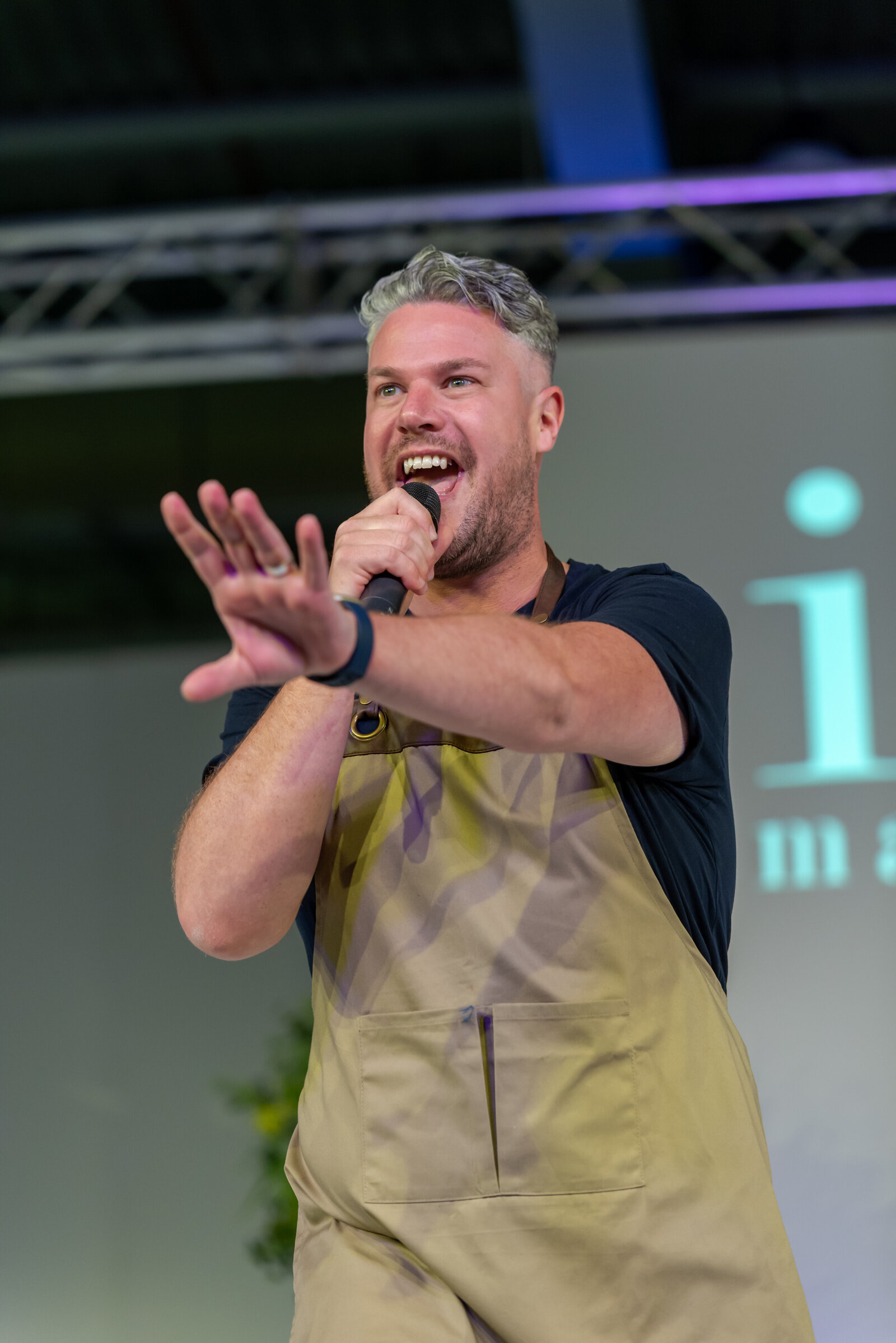 Singing waiter performing on stage at an awards event